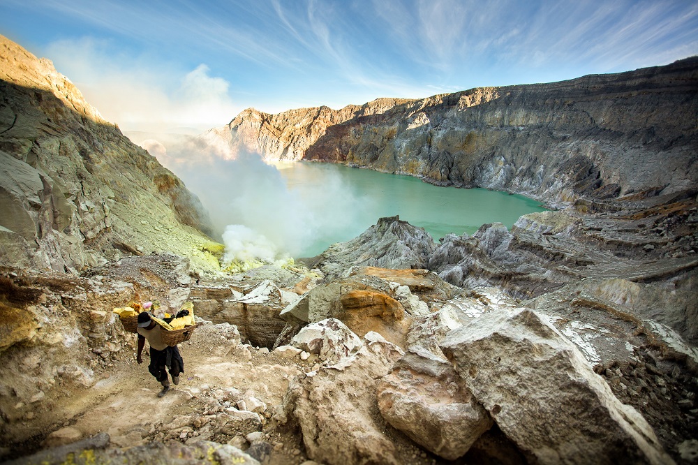 Miners are carrying sulfur from Ijen Volcano Blue flames , Indonesia